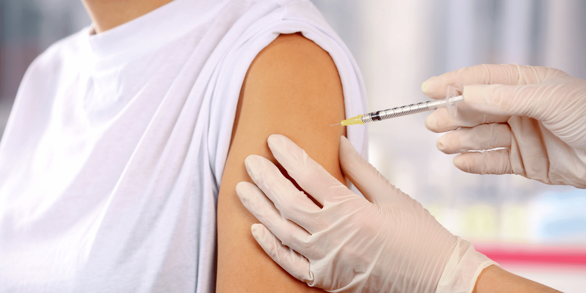Doctor giving injection in arm