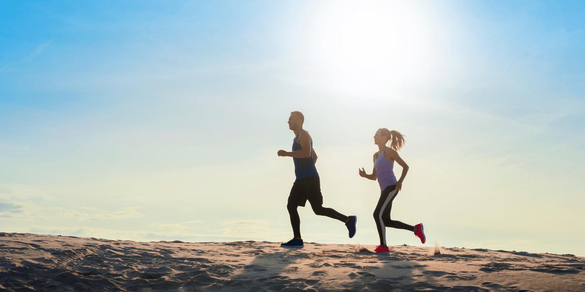 Man and woman running on a beach