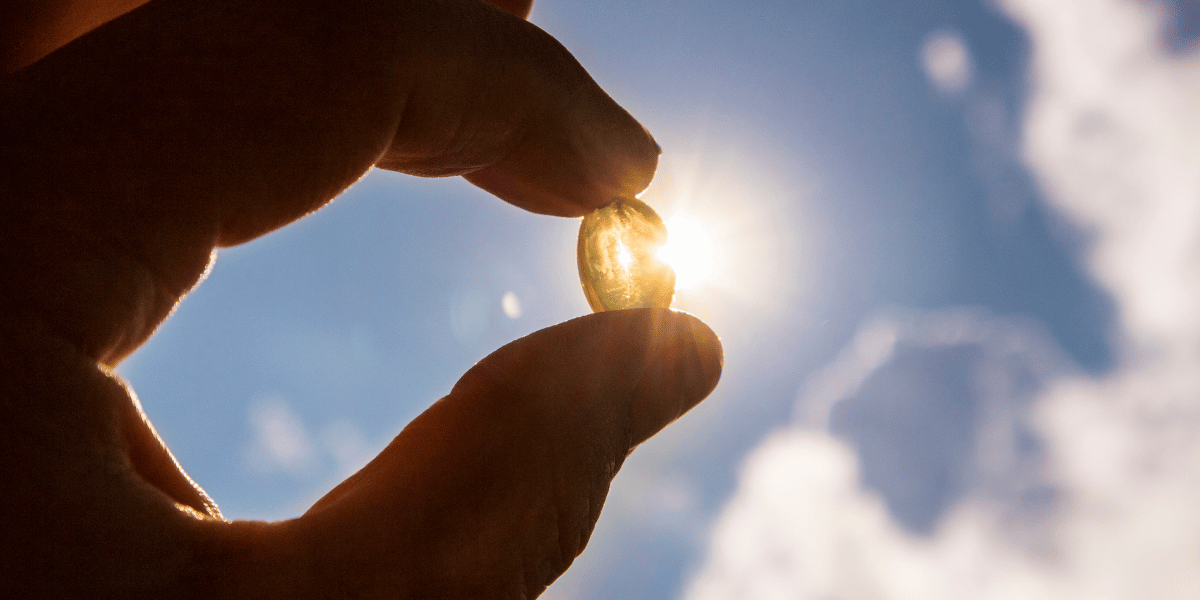 Vitamin D pill held up to sunlight